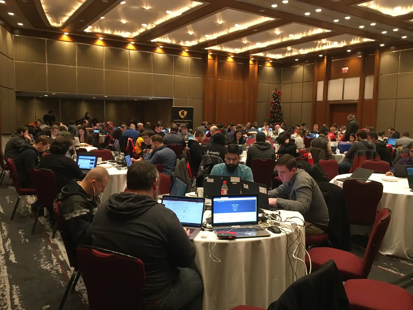 Attendees working on laptops at a Xanthus Security event